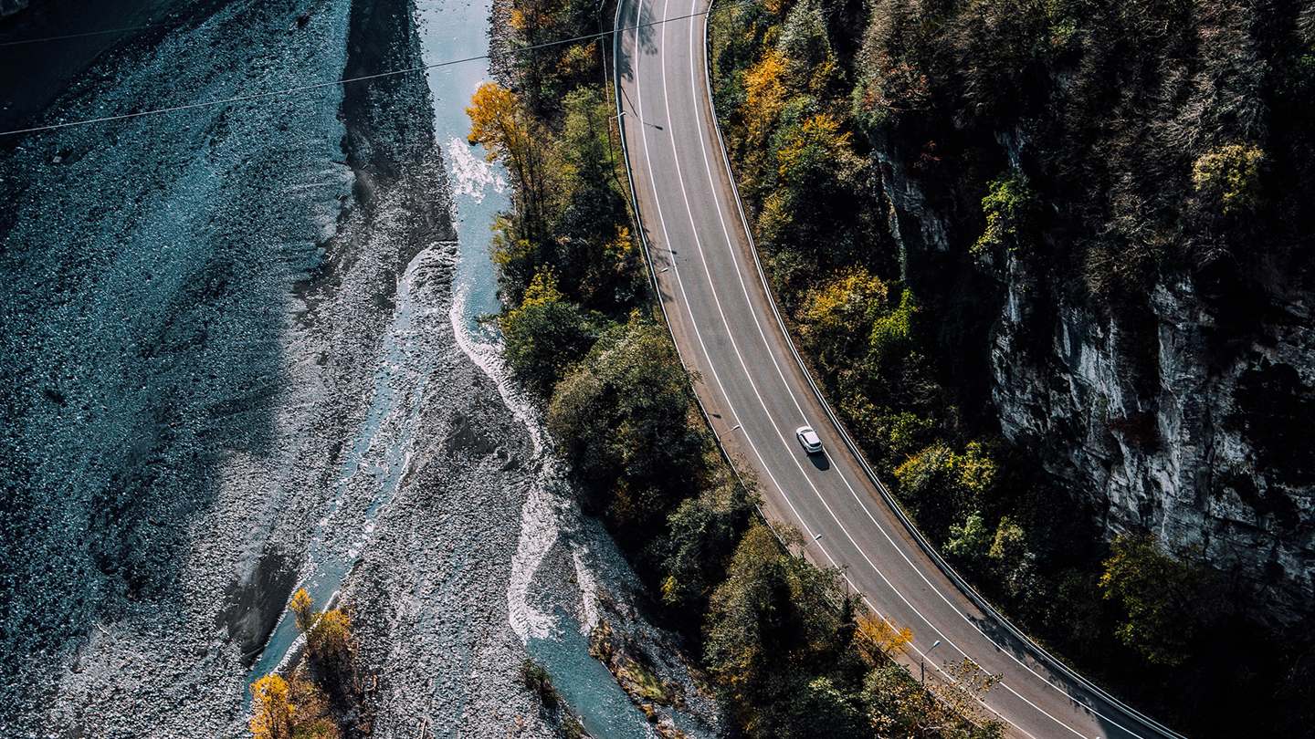 A car on a mountain road, seen from above